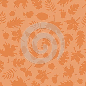 Fall leaves seamless vector background. Orange leaf silhouettes on light orange. Acorns, oak tree, maple tree pattern. Subtle