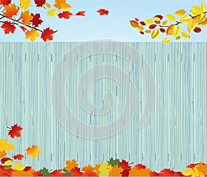 Fall leaves by wood fence