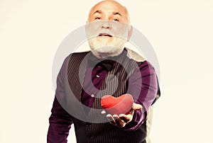 Fall in love. Heartbeat diagnostics and treatment. Health care. Senior bald head bearded man hold red heart. Mature man