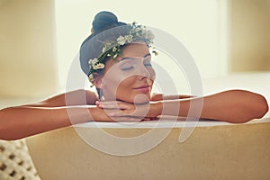 Fall in love with your skin. a beautiful nude woman relaxing in a bathtub at home.