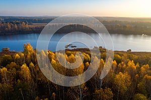 Fall morning. Aerial view lake surrounded forest