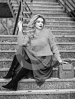 Fall outfit formula. Style Sweater and Skirt Combo for Fall. Woman gorgeous hairstyle sit on stairs outdoors. Warm