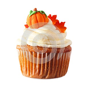 Fall pumpkin spice cupcake with creamy frosting, leaf and pumpkin toppings isolated on white