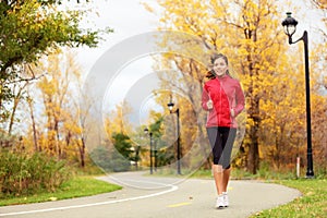 Fall running - woman jogging in autumn