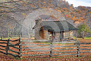 Fall with rustic cabin and fence