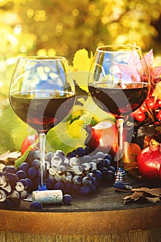 Fall scene with glasses of red wine and grapes