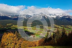 Fall scenery of Ellmau, a beautiful village in the grassy valley at the foothills of a majestic alpine mountain range photo