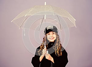 Fall season. Kids fashion trend. Love rainy days. Kid girl happy hold transparent umbrella. Enjoy rainy weather with