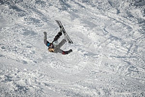 fall of a snowboarder while sliding down a snow-covered slope