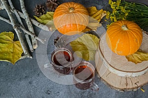 Fall Thanksgiving and Halloween. Oktoberfest. Autumn harvest. Ripe pumpkins, yellow leaves, birch branches, cones, mugs