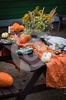 Fall themed holiday table setting arrangement for a seasonal party