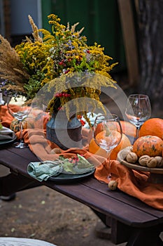 Fall themed holiday table setting arrangement for a seasonal party