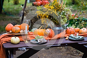 Fall themed holiday table setting arrangement for a seasonal party