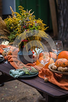 Fall themed holiday table setting arrangement for a seasonal party