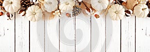 Fall top border of white pumpkins and brown autumn decor on a white wood banner background