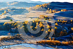 The fall trees on hillside and river