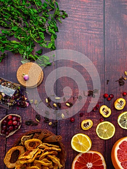 Fall and winter ingredients still life with grapefruits, lemon,cydonia, cranberries, herbs, dried apples, cinnamon sticks, spices