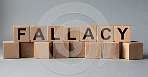 FALLACY, the inscription on wooden cubes on a white background