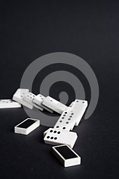 Fallen dominoes domino effect lose fail concept black background