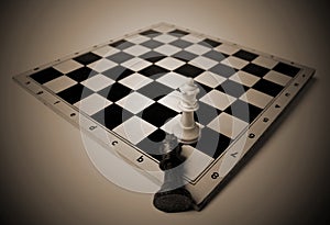 Fallen king on chess board