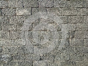 Old wall made of dense beautiful bricks with cement