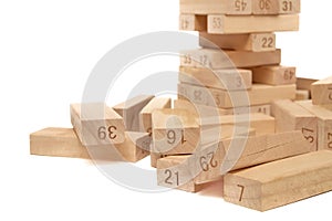 Fallen wooden blocks from the Jenga Tower game on a white background close-up. Home entertainment