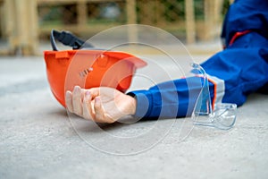 fallen worker on floor with his helmet, accident injury