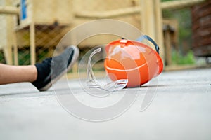 fallen worker on floor with his helmet, accident injury