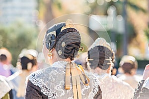 Fallera hairstyle detail, typical celebration of Valencia on a sunny day