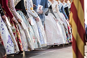 Falleras on a stage receiving an award. Detail of the typical dresses of the fallas of Valencia photo