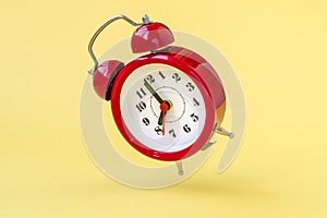 Falling alarm clock showing eight o`clock