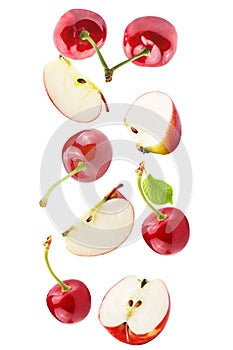 Falling apple and cherries isolated on white background