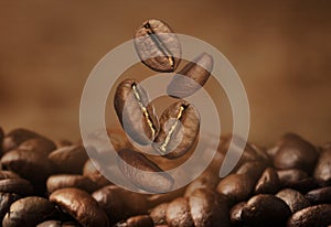 Falling aromatic roasted coffee beans, closeup view