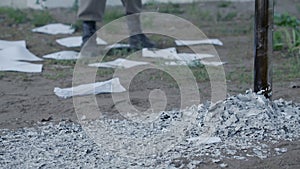 Falling ash of white paper sheets on ground