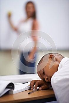 Falling asleep in class. A young boy sleeping in class.