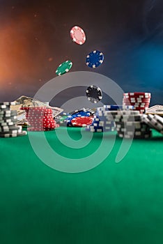 Falling chips on a poker table in a casino. Online poker bets