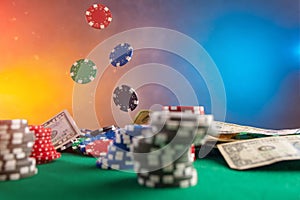 Falling chips on a poker table in a casino. Online poker bets