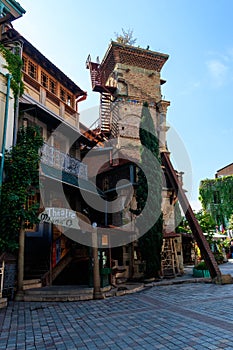 Falling Clock tower of puppet theater Rezo Gabriadze in old town of Tbilisi, Georgia photo