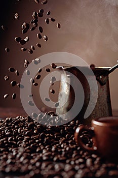 Falling coffee beans and old copper coffee maker