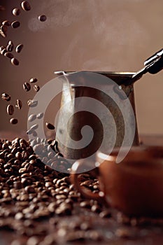 Falling coffee beans and old copper coffee maker