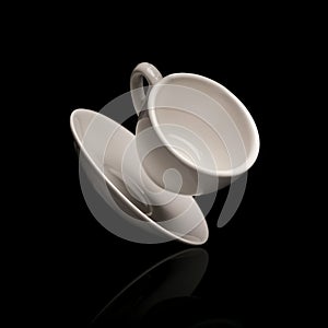 Falling coffee cup with saucer