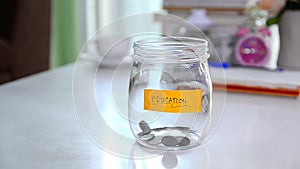 Falling of coins to glass jar concept to saving money with copyspace