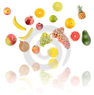 Falling colorful vegetables and fruits with light reflection isolated on white