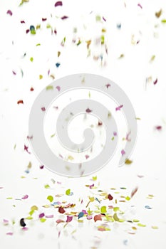 Falling confetti over white background