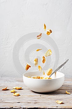 Falling cornflakes into a bowl