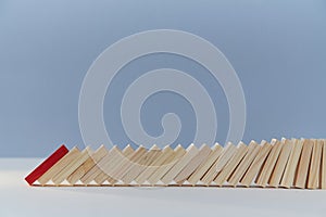 Falling domino blocks, red plank, copy space. Beginning of end. Financial difficulties. Total collapse, economic crisis