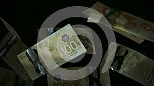 Falling flying american canadian dollar banknotes on a black background. High quality falling Dollar banknotes