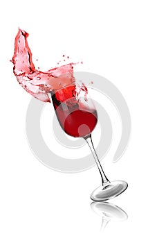 Falling glass with red splashing wine on white background