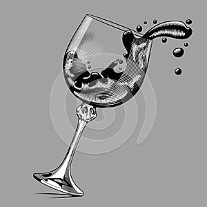 Falling glass with splashed wine on gray