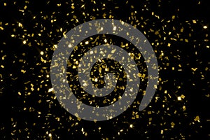 falling golden metallic glitter foil confetti, animation movement on black background, gold holiday and festive fun concept